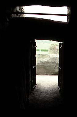Colour photograph leaving passage at Newgrange. Notice light box where sun enters chamber.